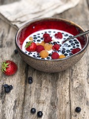 Fresh berries bowl with milk