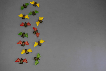 multicolored gummy jelly bat candies over dark background
