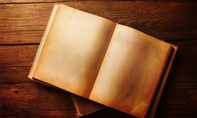 Open book on old wooden table