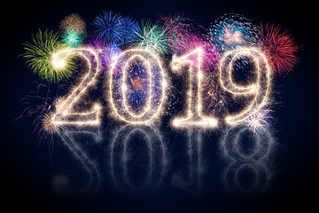 colorful fireworks display and bright sparkler pyrotechnic number 2019 2018 change happy new year sylvester concept on black blue background
