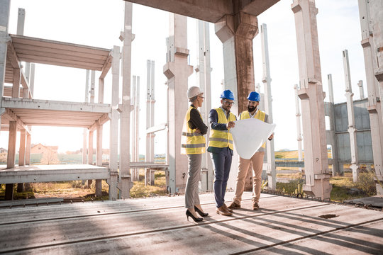 Two building engineers are thrilled with the new solutions of a young beautiful female architect.