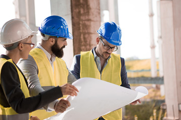 The investor is very curious looking at new solutions on blueprints from the young architect...