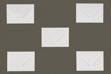 close-up view of closed white envelopes isolated on grey background
