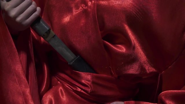 Close up of pulling out the dagger