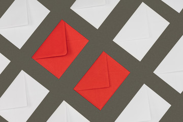 closed red and white envelopes isolated on grey background