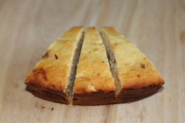 Sliced homemade cake on wooden desk