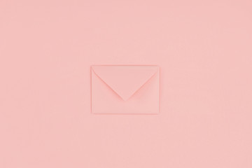 close-up view of single closed pink envelope isolated on pink