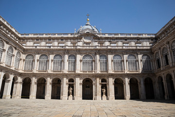 Obraz premium Arches in the yard of majestic, beautiful Royal Palace of Madrid (Palacio Real de Madrid) in the center of the city in the sun rays