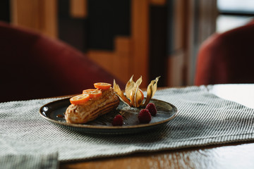 eclair cake on a plate decorated with citrus