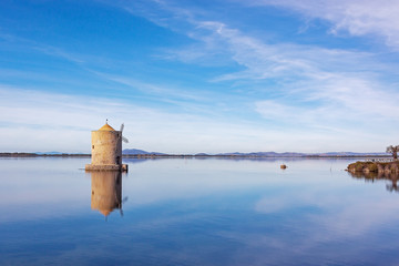 Picturesque old windmill in the lagoon Orbetello on the peninsula Argentario in Tuscany, Italy