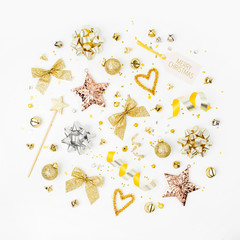 Christmas decorations, bows, stars,  bells in gold colors on white background with empty copy space for text. Holiday and celebration. Flat lay, top view