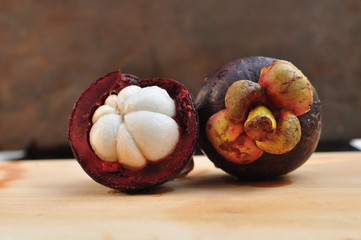 Mangosteen fruit, cross section showing the thick purple skin, queen of fruits.