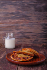 Akok Kedut on wooden plate over the wooden table. Akok Kedut is a traditional dish in Malaysia especially East Coast.