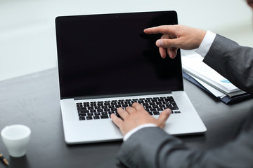 closeup. business colleagues discussing information with a laptop.