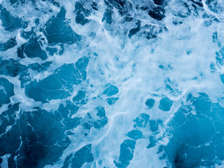 Boat wake on blue sea close up