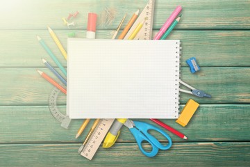 Fototapeta na wymiar Colorful school supplies on blackboard background