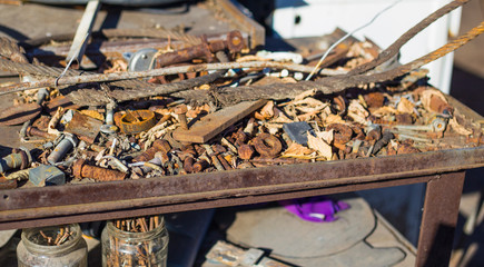 Rusty iron parts lie on the table.