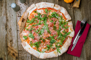Pizza with Parma ham and arugula