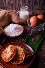 Akok Kedut, egg, coconut, flour , coconut milk and  Pandan leaf on wooden background. Akok Kedut is a traditional dish in Malaysia especially East Coast.