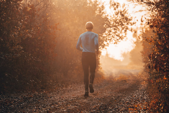 Man Run At Autumn Morning. Healthy Lifestyle Concept