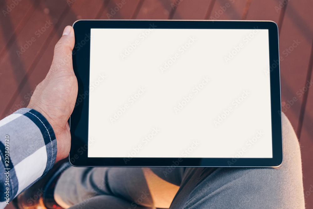 Poster Mockup tablet screen, Man using tablet computer while Stand relax with Clipping path on screen for easy replace you design mock up