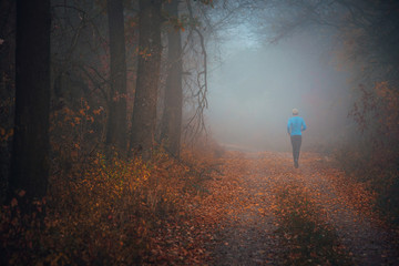 Man train in autumn morning nature. Running sport photo.