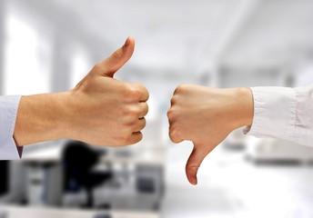 Cropped photo of two businessmen showing Thumb Up and Thumb Down
