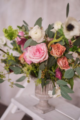 Autumn bridal bouquet of flowers stands on the white staircase stepladder