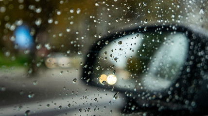 rainy weather, autumn time. drops on the vehicle's windows and blurry effect. rainy season and cold and cool weather. drops of rain on glass.