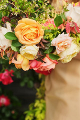Wedding Photography: A bride in a silk wedding dress holding a beautiful big white, blush, pink, peach, orange wedding bouquet