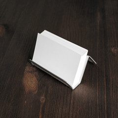 Fototapeta premium Blank business cards on metal holder at wooden background. Responsive design mockup.