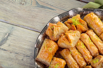 Turkish sweets baklava and metal oriental tray on wooden background