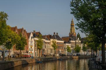 Fototapeta premium groningen, NETHERLANDS - August 28, 2018: Water and street in Groningen center. Church in the back
