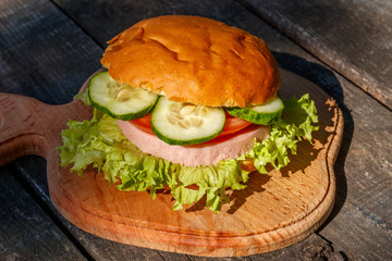 Fresh delicious homemade burger on wooden table