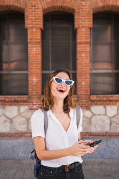 Young woman sight seeing in Madrid, using smartphone