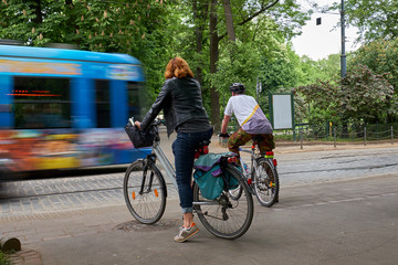 Cyclists wait while the tram passes. Krakow, Poland.