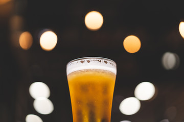chill beer on dark background and light bokeh