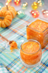 Pumpkin jam or confiture on a cozy kitchen table. Autumn background. Selective focus.