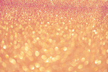 Pink and gold abstract bokeh lights. Shiny glitter background with copy space. New year and Christmas concept. Sparkling greeting card