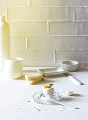 Fototapeta na wymiar Traditional morning breakfast, boiled eggs, butter, bread, milk, on a white background, modern style