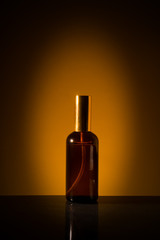 Fototapeta premium Cosmetic product launch or presentation in a minimalist concept. Spotlight shone on the product with dark yellow background