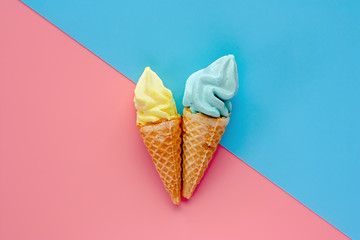 Two of ice cream cone on pink and blue background for sweet and refreshing dessert concept