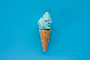 Ice cream cone on blue background for sweet and refreshing dessert concept