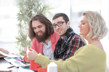 group of designers discussing fabric samples in the Studio