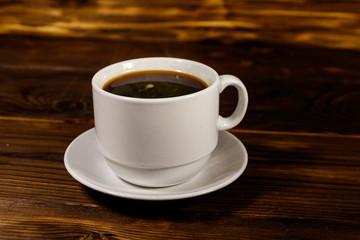 Cup of coffee on the wooden table