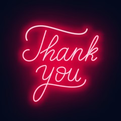 Neon lettering thank you on a dark background.