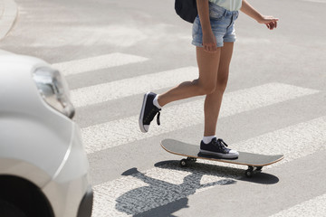 Girl on skateboard on pedestrian crossing