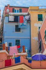 Colorful buildings and colorful clothes hanging out to dry.  Taken in Vernazza, Italy in the Cinque Terre, Liguria areas of Italy. 