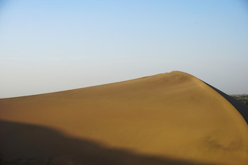 Fototapeta na wymiar Desert sand dunes with blue sky, natural, beauty.