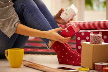 Woman preparing presents for family and friends for Christmas and New Year. Holiday concept.